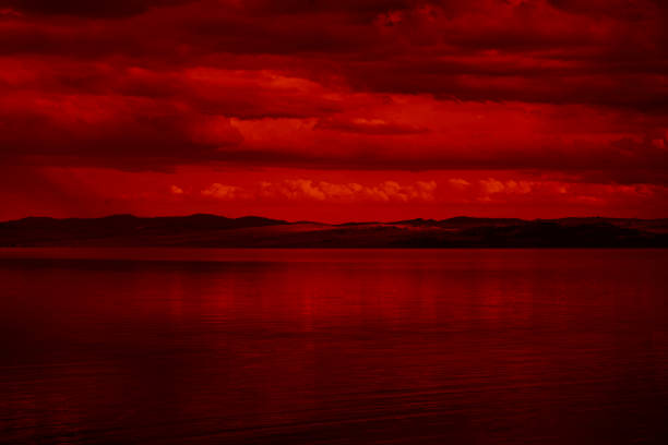 The surface and the island of red water scenery. Sky with clouds. Bloody sunset
background with copy space for design. War, apocalypse, armageddon, nightmare,...